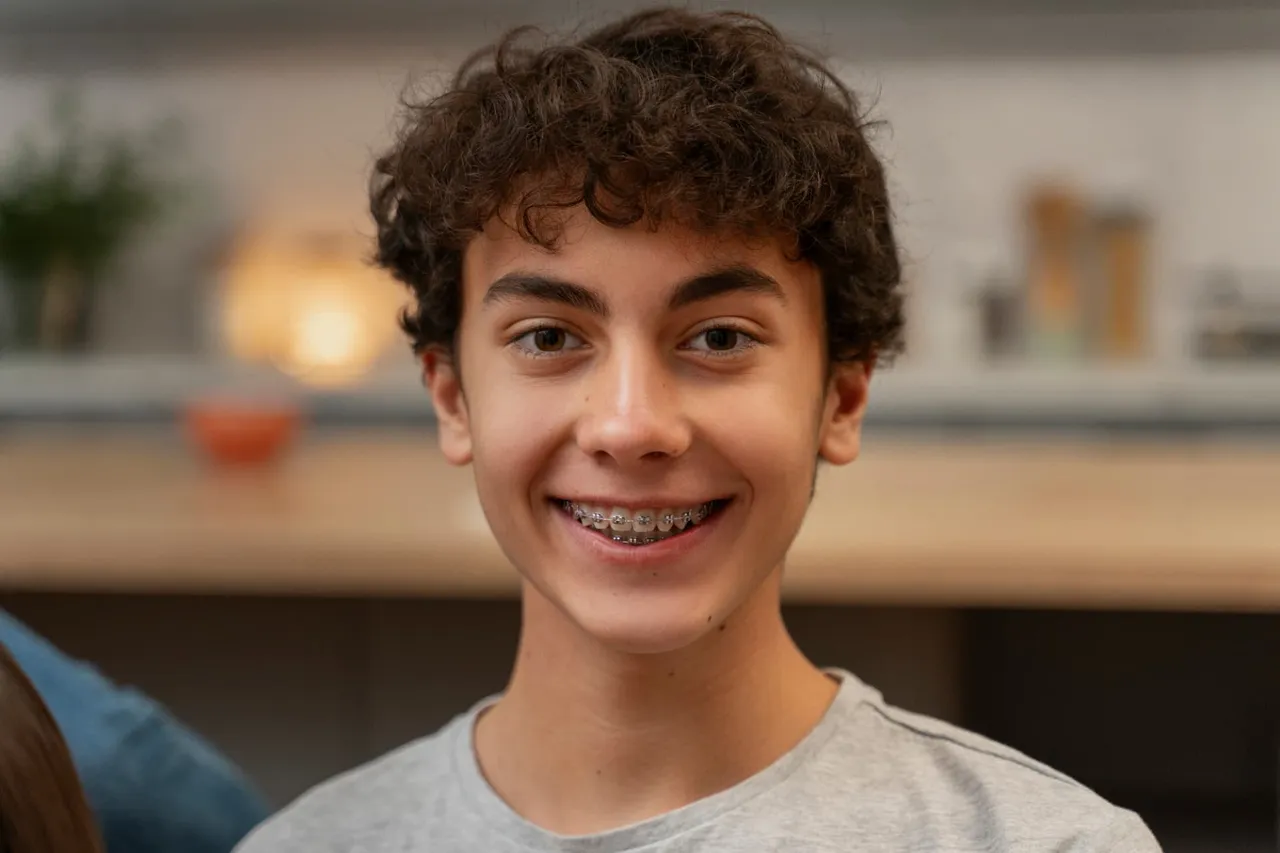 Young person smiling with metal braces