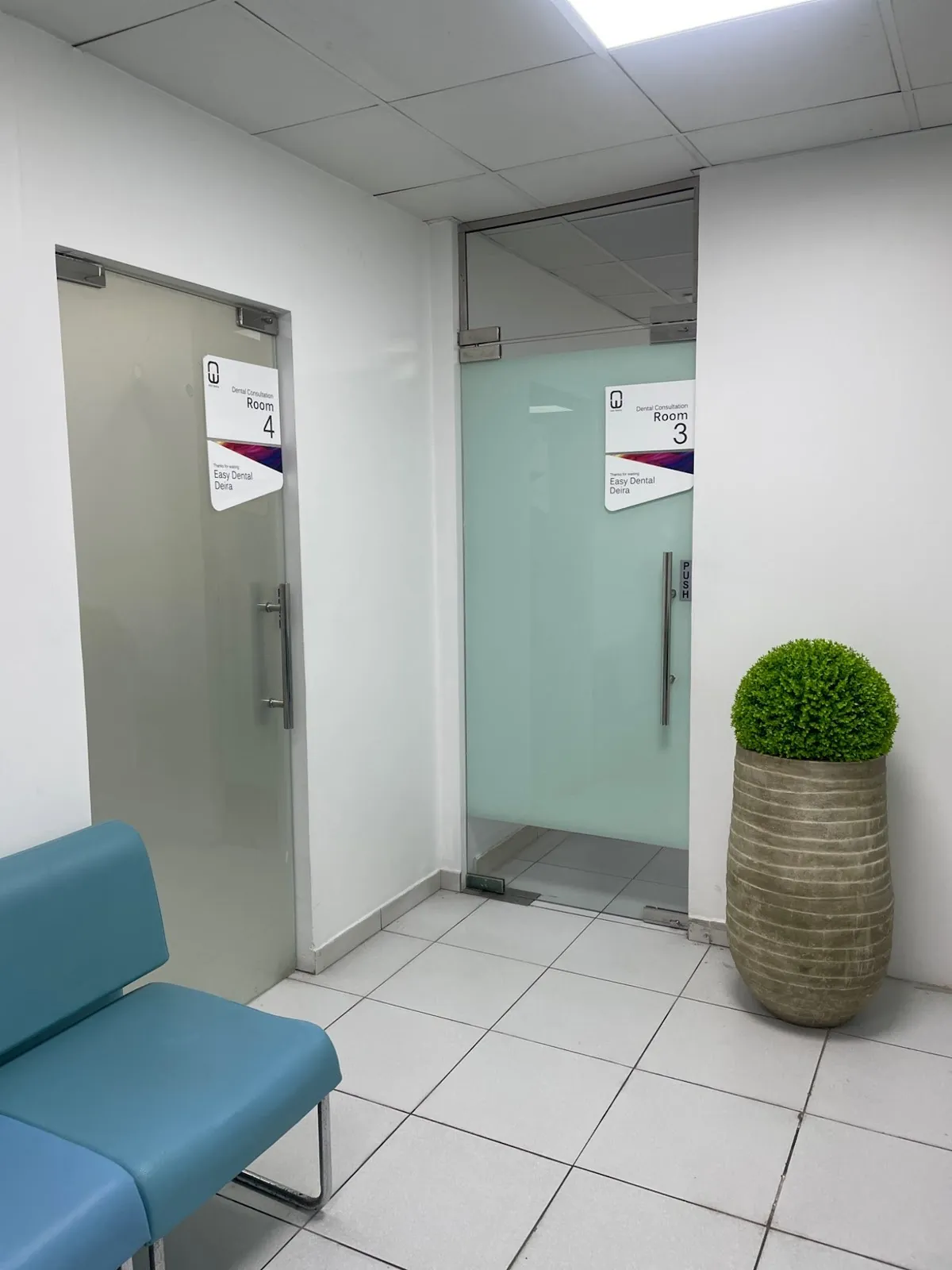 Waiting area with blue chairs outside rooms 3 and 4, Al Rigga (Deira)