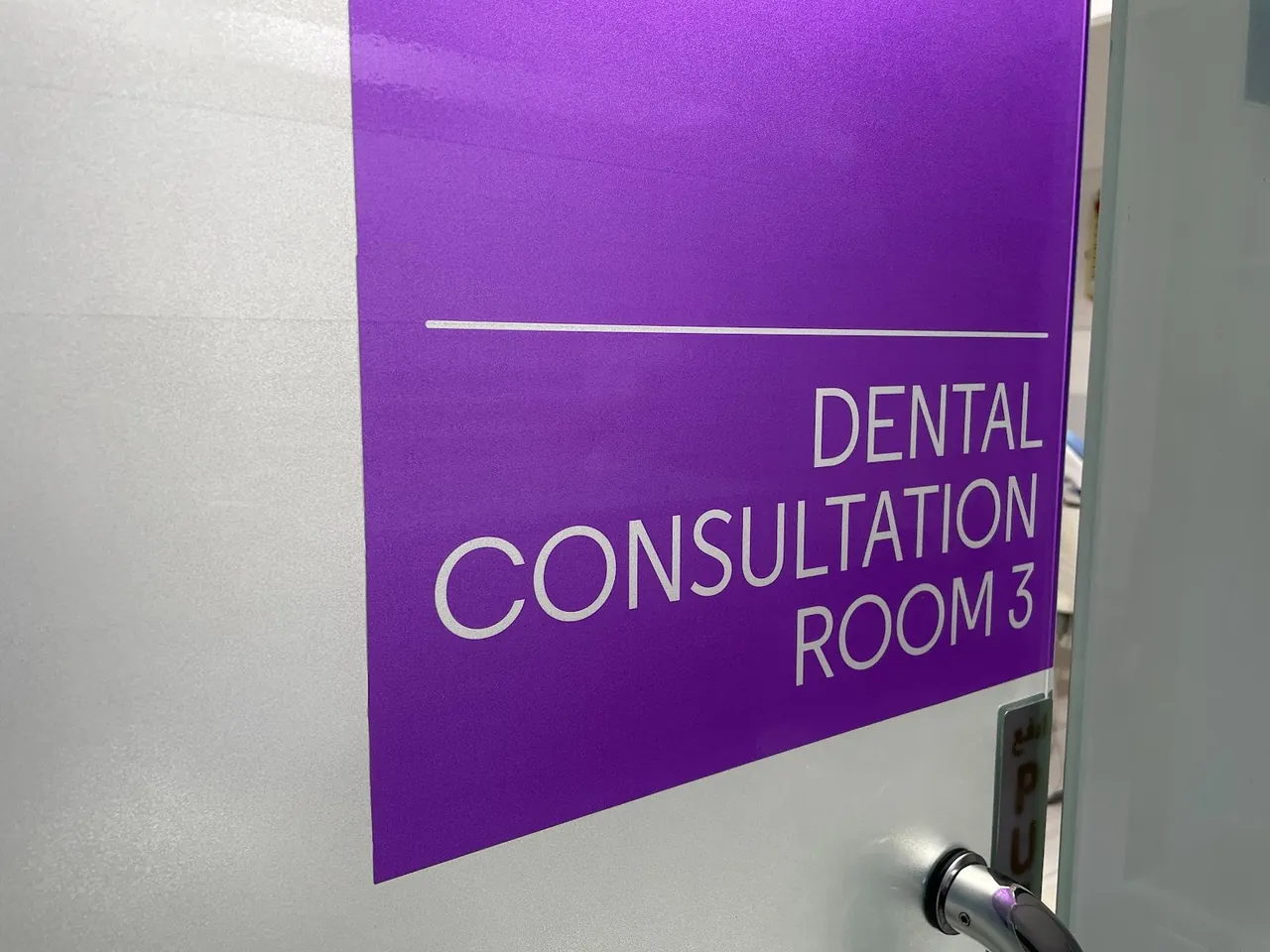 Door sign reading Dental Consultation Room 3, Al Satwa