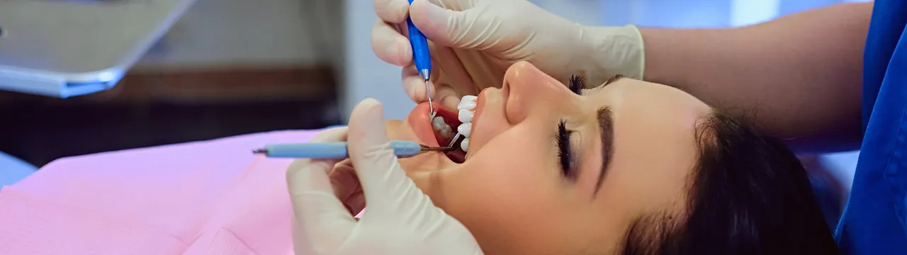 Dentist checking a patient's gums