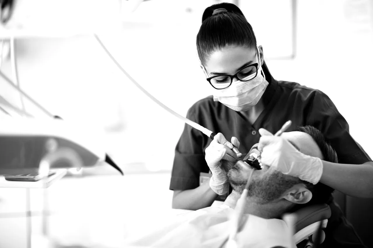 Dentist carrying out restorative treatment on a patient