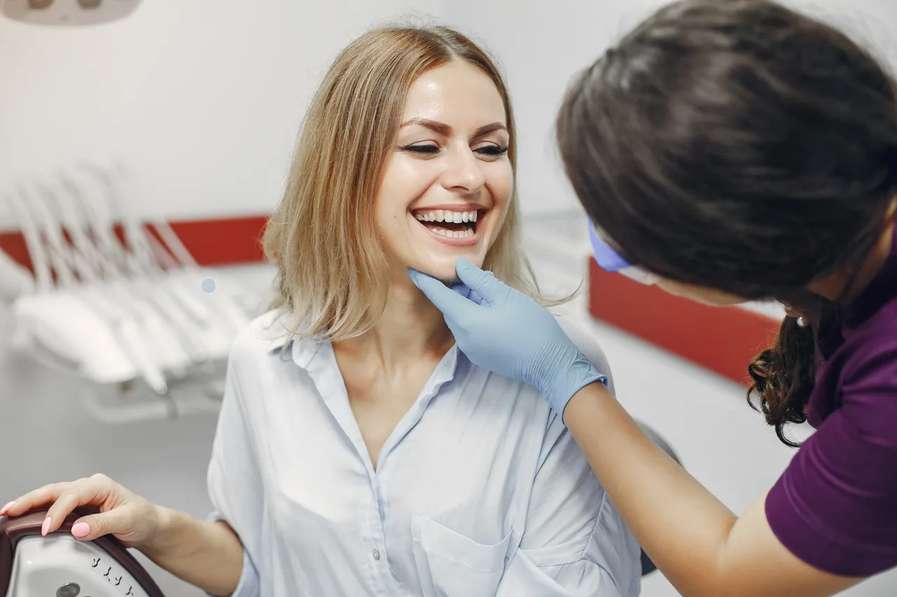 Dentist examining a smiling patient's teeth