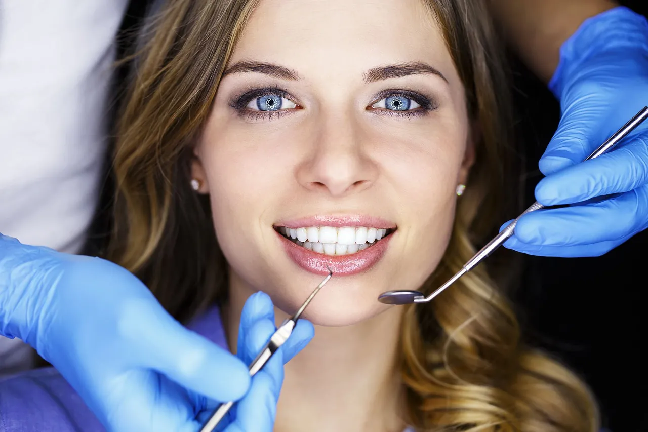 Dentist examining a patient's teeth during a cleaning check-up